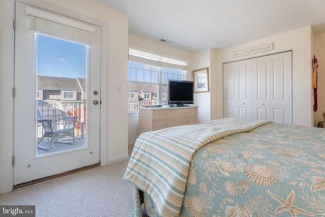 carpeted bedroom featuring access to exterior and a closet