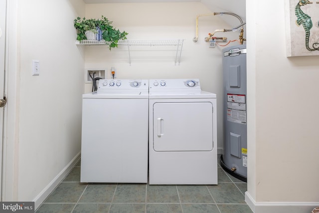 washroom featuring tile patterned floors, water heater, and washer and dryer