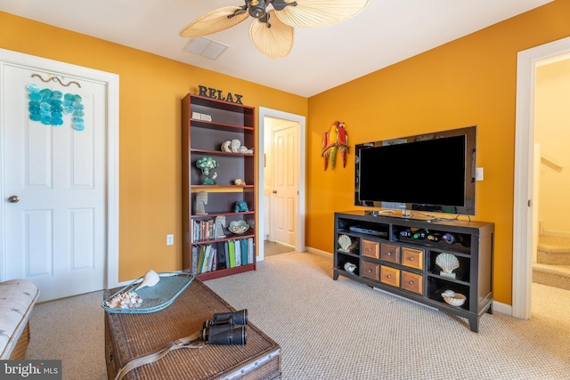 carpeted living room with ceiling fan