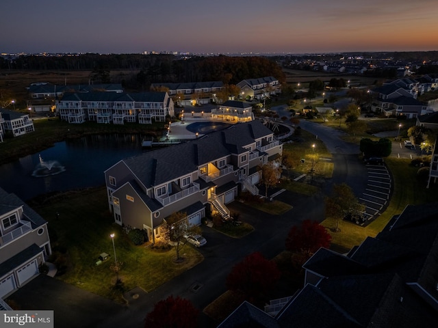 aerial view at dusk with a water view