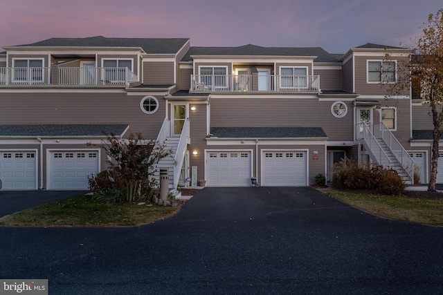 multi unit property featuring a balcony and a garage