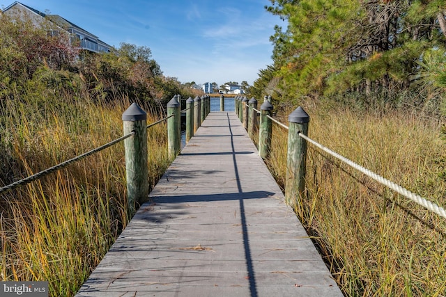 view of property's community featuring a boat dock and a water view