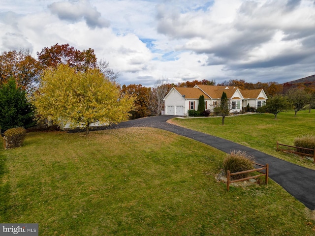 view of front of house with a garage and a front lawn