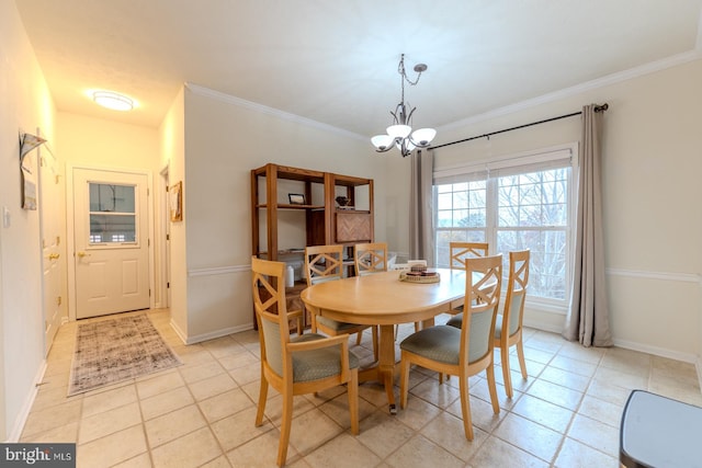 dining room with an inviting chandelier, light tile patterned floors, and crown molding