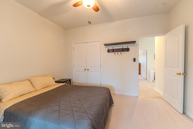 carpeted bedroom featuring a closet and ceiling fan