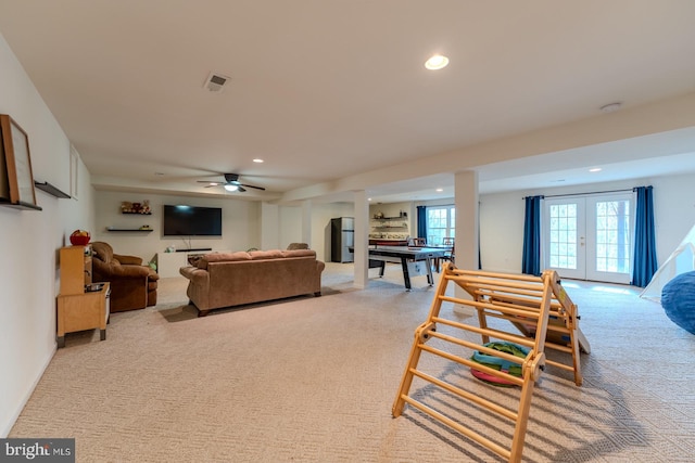 living room featuring french doors, ceiling fan, and carpet floors