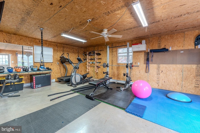 exercise area with concrete flooring and ceiling fan