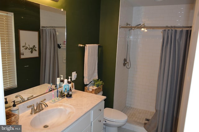 bathroom with vanity, curtained shower, toilet, and tile patterned flooring