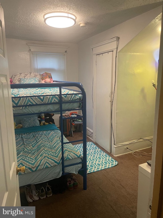 bedroom featuring carpet floors and a textured ceiling