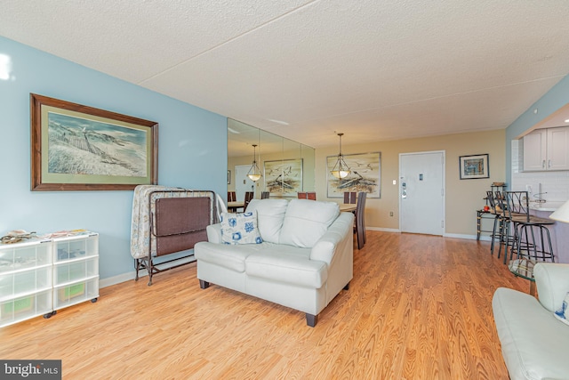 living room featuring a textured ceiling and light hardwood / wood-style flooring