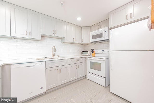 kitchen featuring decorative backsplash, sink, light tile patterned floors, white cabinets, and white appliances