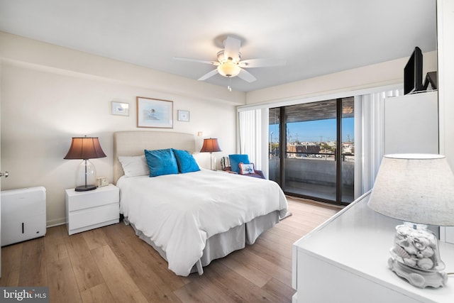 bedroom with light wood-type flooring, access to outside, and ceiling fan