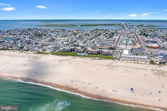 bird's eye view with a water view and a beach view