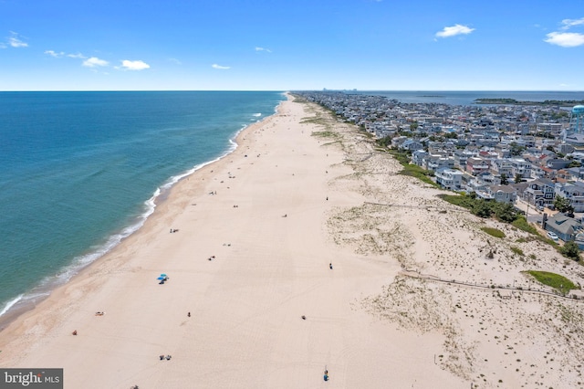 drone / aerial view featuring a water view and a beach view