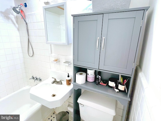 bathroom with backsplash, toilet, and sink