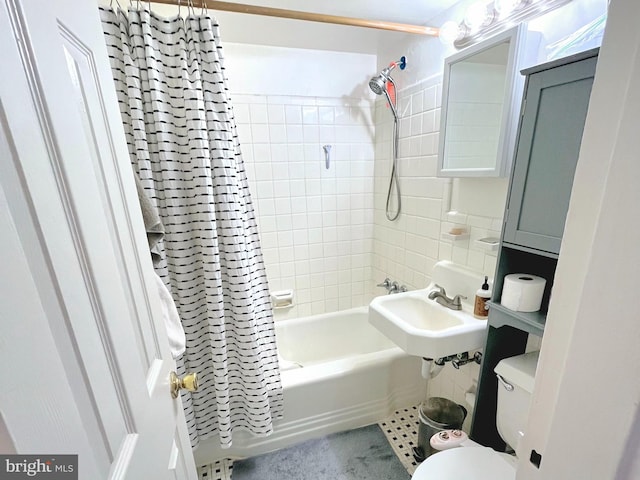 full bathroom with sink, shower / tub combo, and toilet