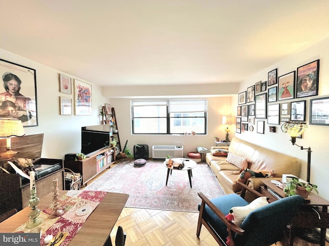 living room featuring a wall mounted air conditioner and light parquet flooring