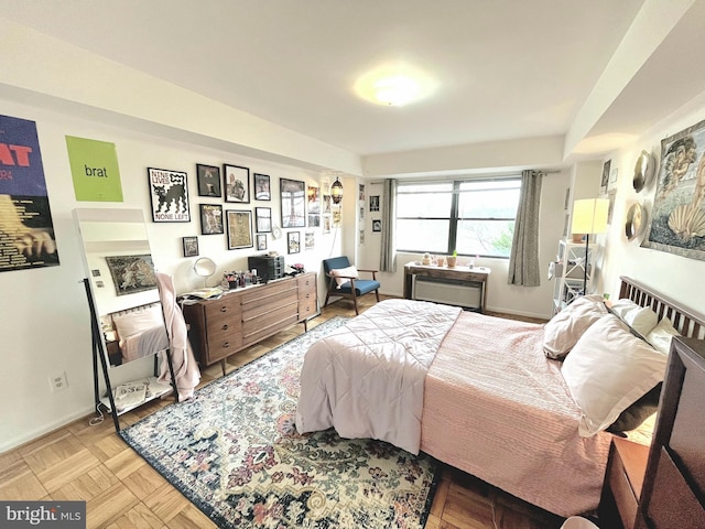 bedroom with light parquet floors