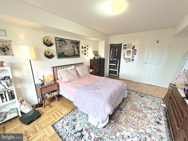 bedroom with a closet and light parquet flooring