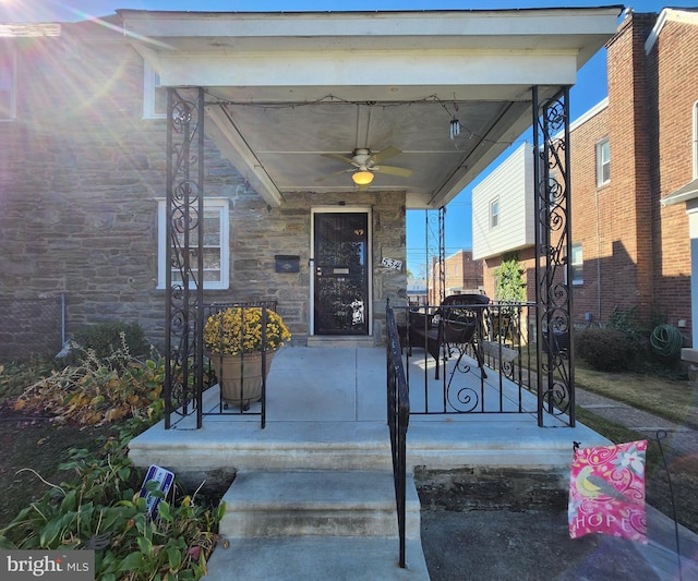 view of exterior entry with ceiling fan