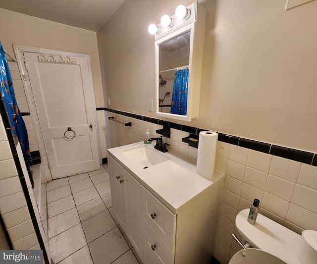 bathroom featuring tile walls, tile patterned floors, walk in shower, vanity, and toilet