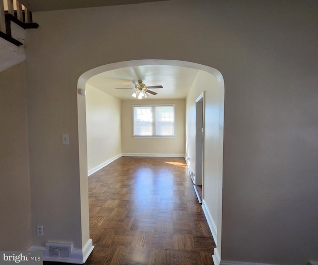 corridor with dark parquet flooring