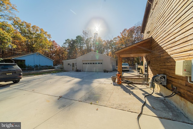 view of property exterior featuring a garage and an outdoor structure