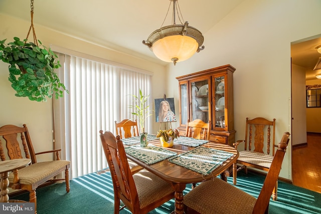 dining room featuring wood-type flooring and lofted ceiling