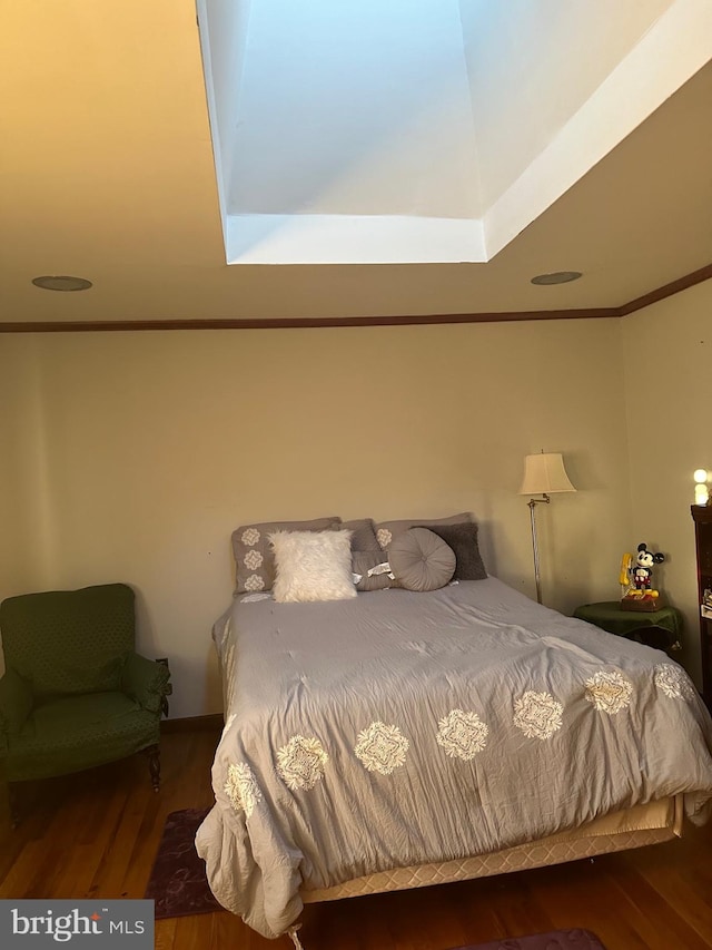 bedroom featuring dark hardwood / wood-style flooring and crown molding