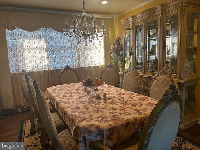 dining space with a notable chandelier, dark hardwood / wood-style floors, and ornamental molding