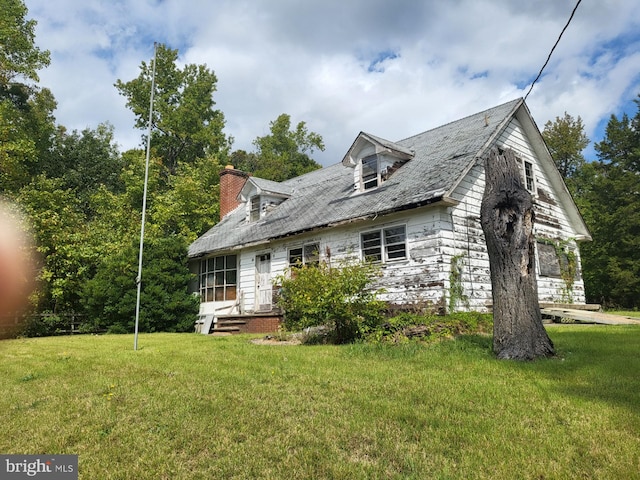 rear view of house with a lawn