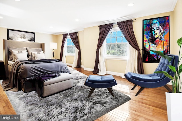 bedroom with hardwood / wood-style floors and crown molding