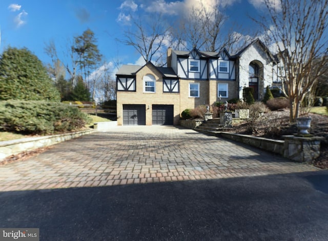 tudor-style house featuring a garage