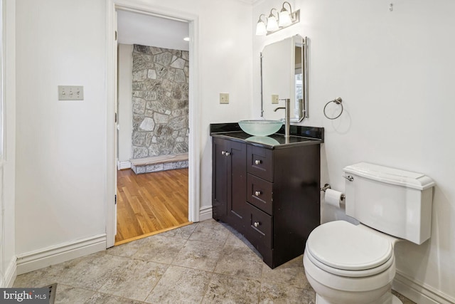 bathroom featuring toilet, vanity, and hardwood / wood-style flooring