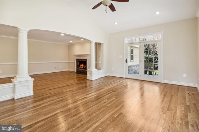 unfurnished living room featuring light hardwood / wood-style floors, high vaulted ceiling, ceiling fan, and ornamental molding