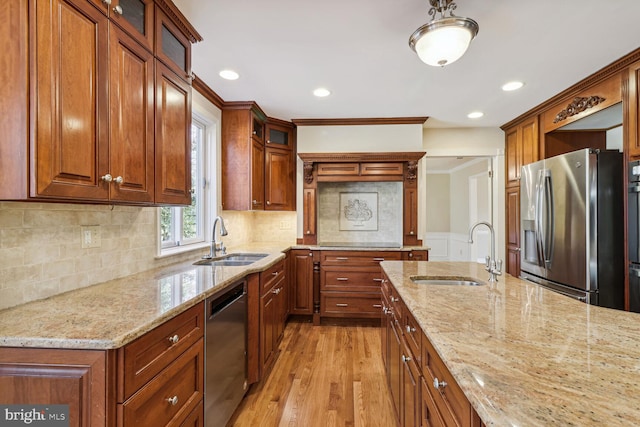 kitchen featuring light stone counters, sink, and appliances with stainless steel finishes