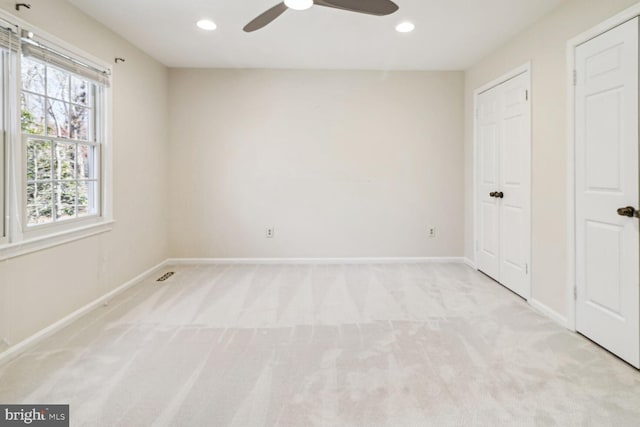 unfurnished bedroom with ceiling fan and light carpet