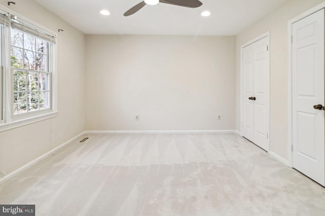 unfurnished bedroom featuring ceiling fan and light carpet