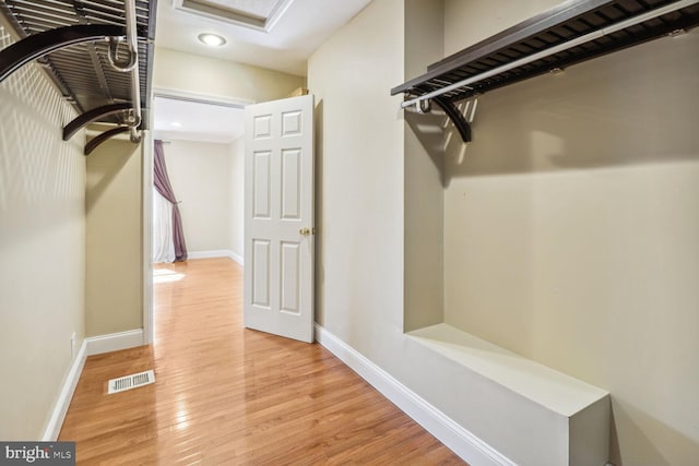 spacious closet with light hardwood / wood-style flooring