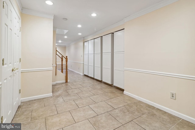 spare room with light tile patterned flooring and ornamental molding