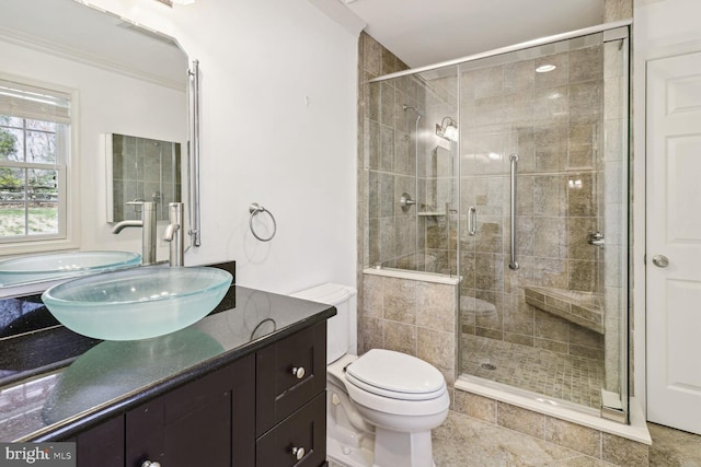 bathroom with toilet, vanity, and walk in shower