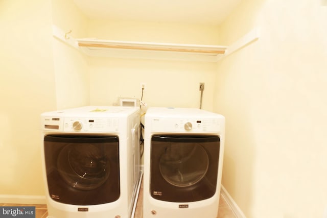 washroom with tile patterned flooring and separate washer and dryer