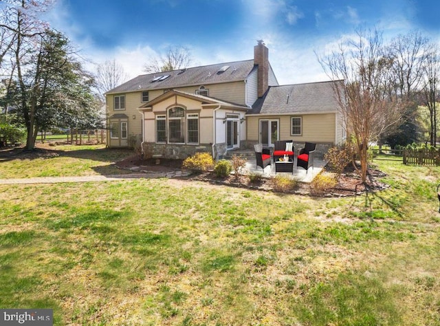 rear view of house with a lawn, a patio, and an outdoor hangout area