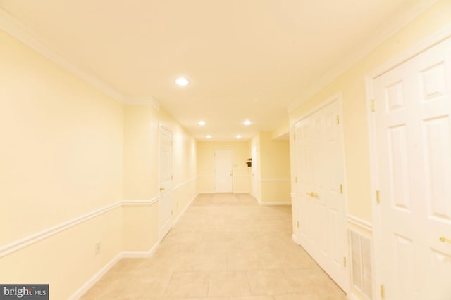 corridor with crown molding and light tile patterned flooring