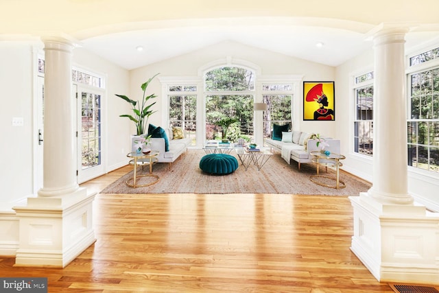 interior space with light wood-type flooring, french doors, and vaulted ceiling