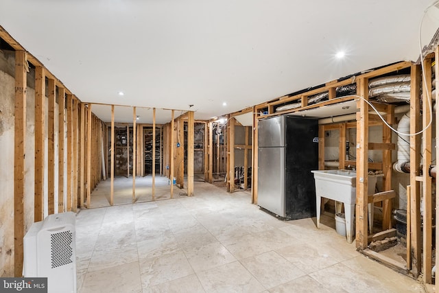 basement with stainless steel fridge