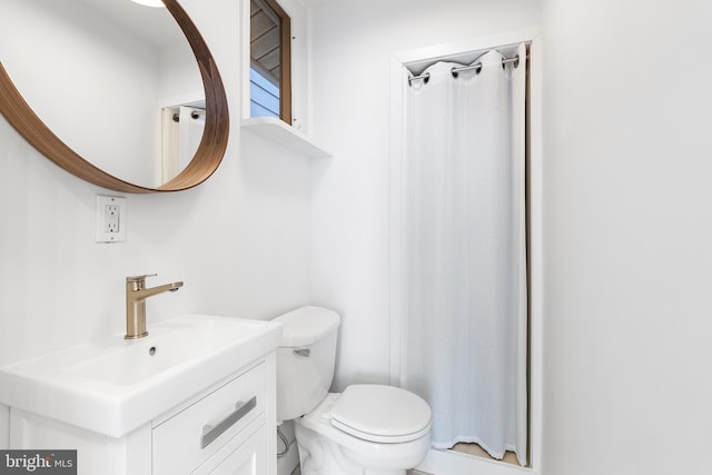 bathroom with vanity, toilet, and a shower with shower curtain