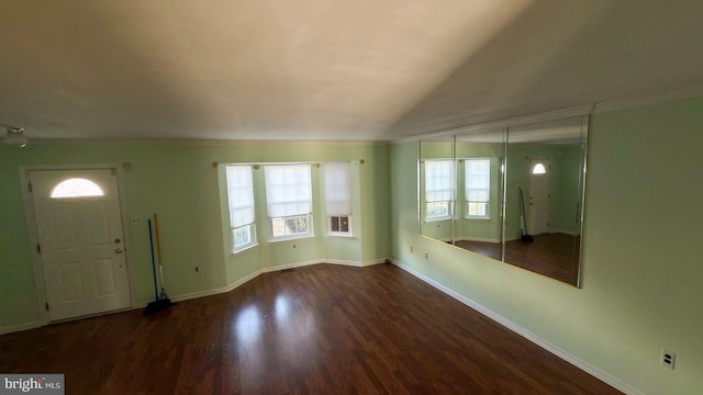 foyer with vaulted ceiling and dark hardwood / wood-style flooring