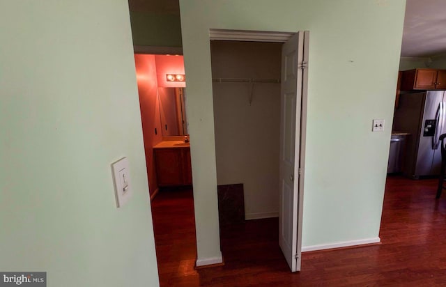 corridor featuring sink, dark hardwood / wood-style flooring, and ornamental molding