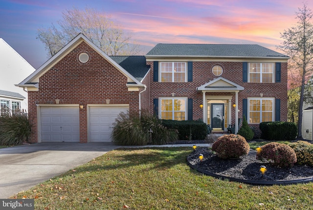 view of front of property with a lawn and a garage